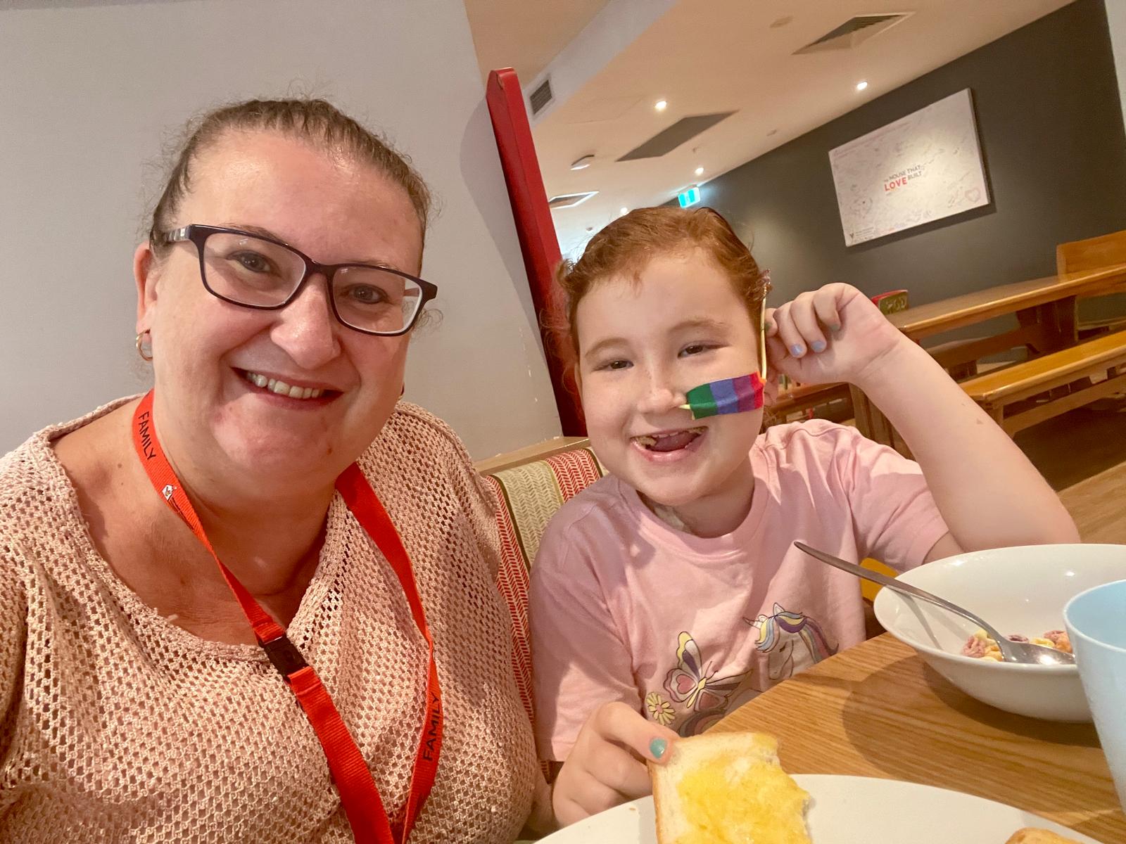 Sick child and her mum having breakfast at Ronald McDonald House in Westmead