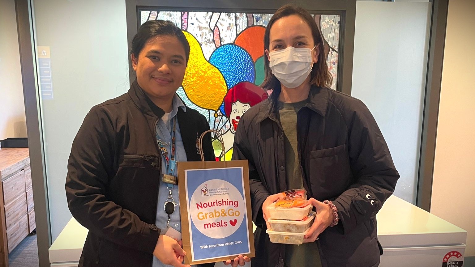 Family receiving treatment at The Children's Hospital at Westmead receiving a Grab&Go meal from Ronald McDonald House Charities Greater Western Sydney