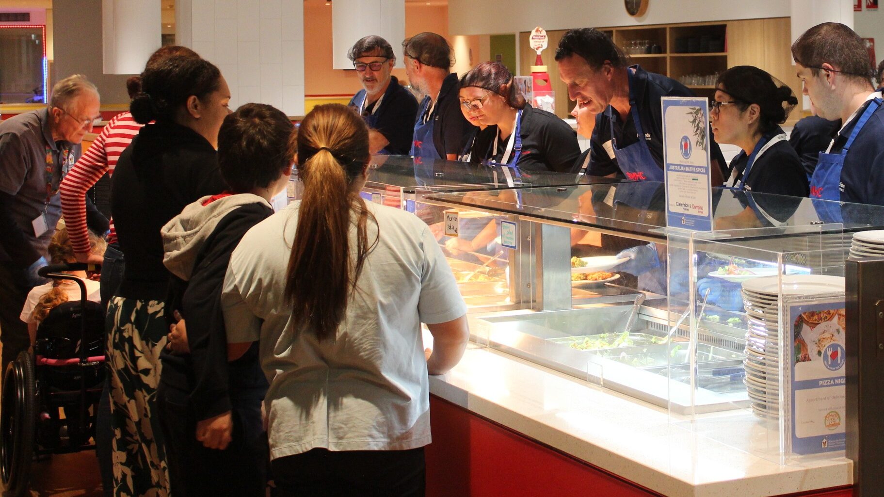 Community group preparing a meal for families of sick kids at Ronald McDonald House in Westmead