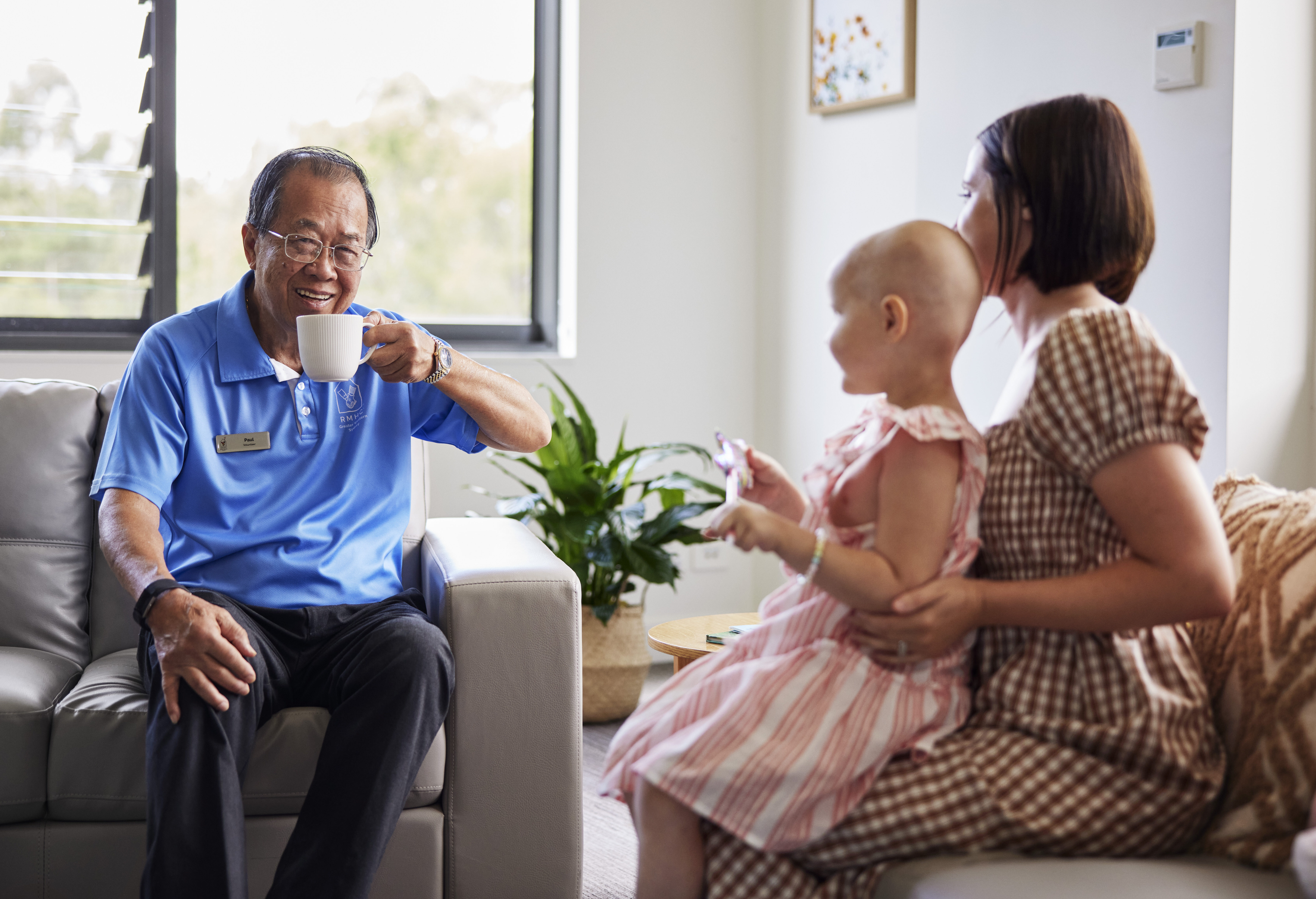 Volunteer at Ronald McDonald House in Westmead spending time with a mother and sick child